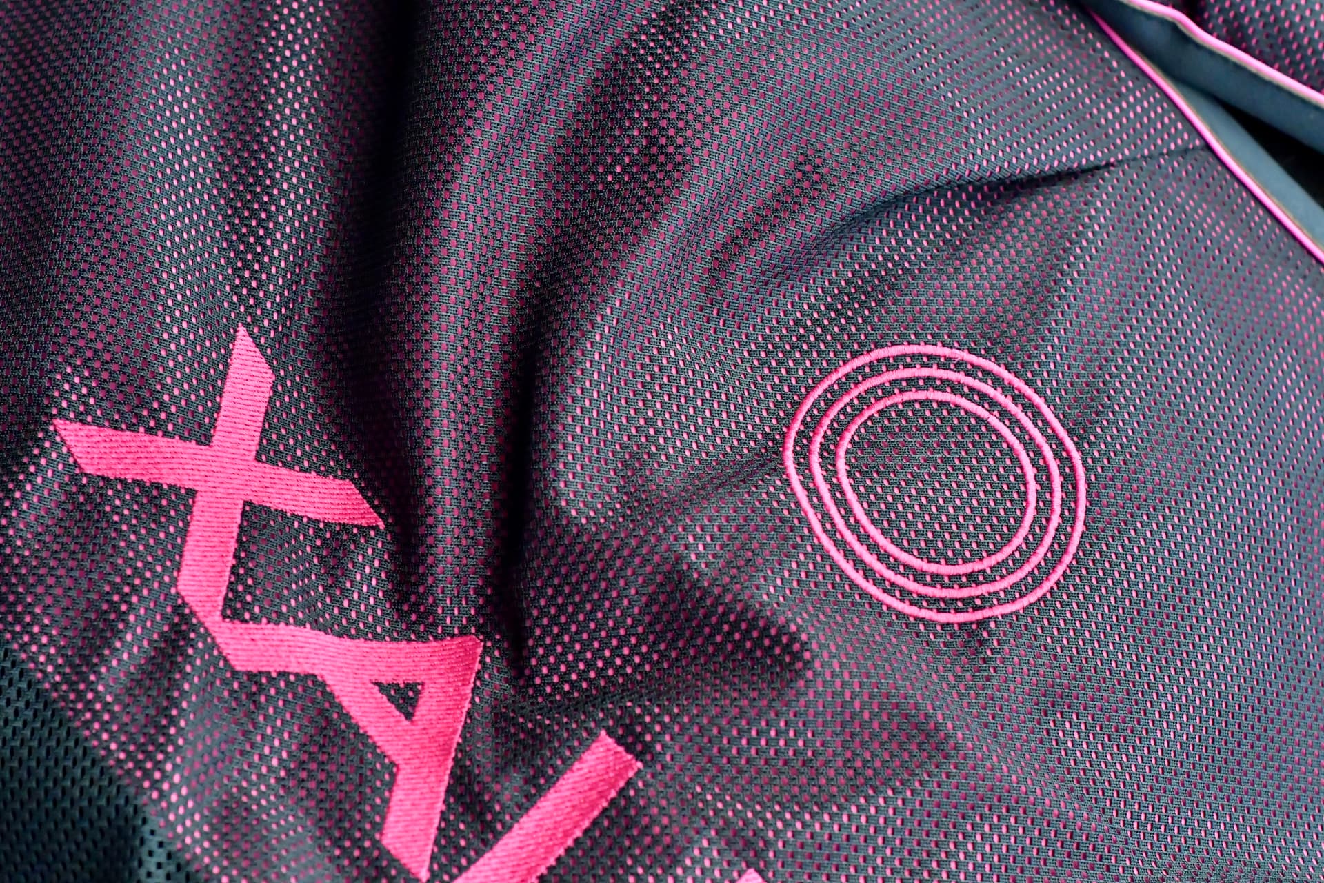 Detail of the XALI therapy blanket's magenta textile and therapy ring